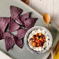 Blue tortilla chips and cottage cheese, topped with Publix Deli Black Bean & Corn Salsa