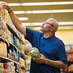 man selecting items from grocery shelf