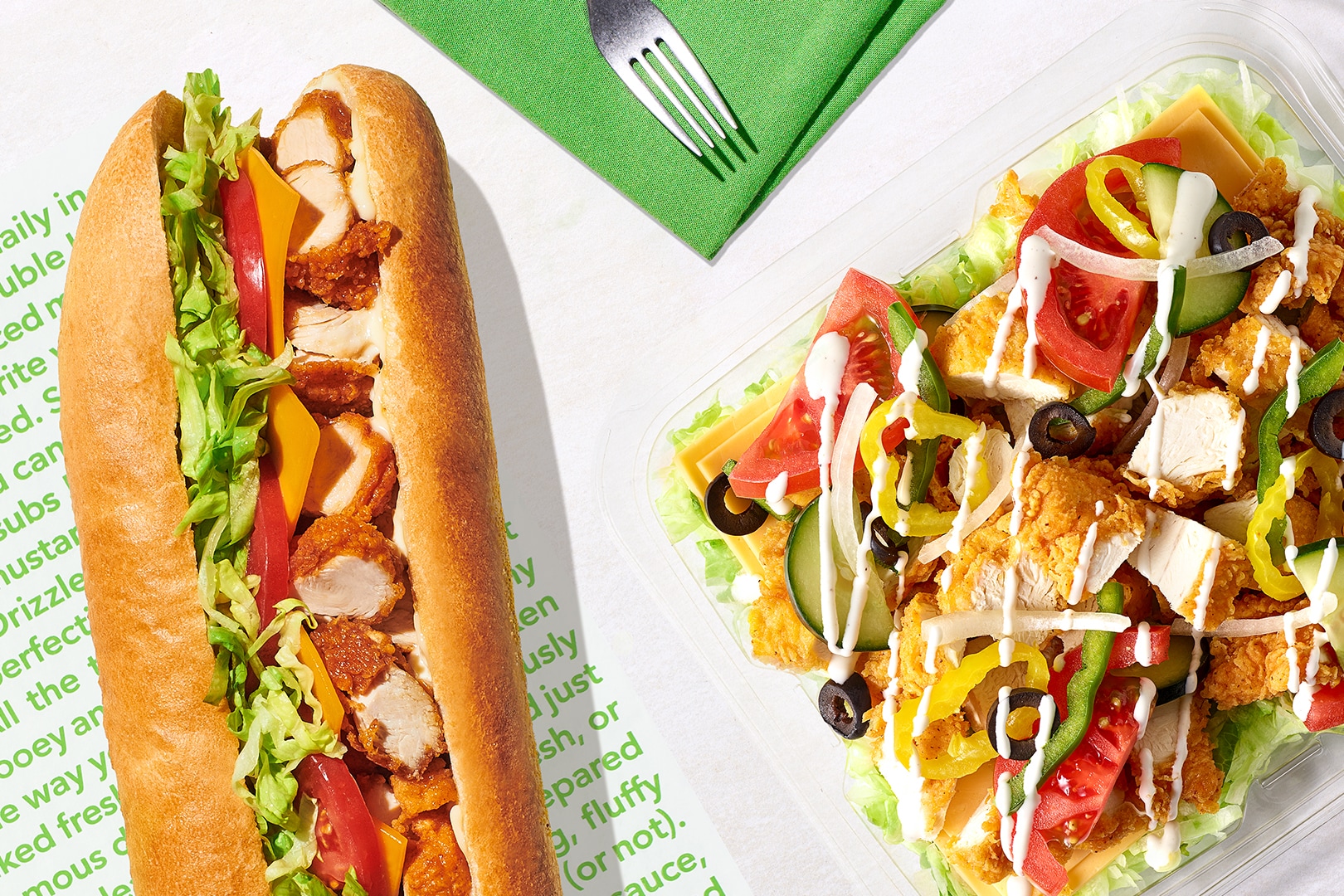  Chicken tender sub and chicken tender  salad on a countertop.