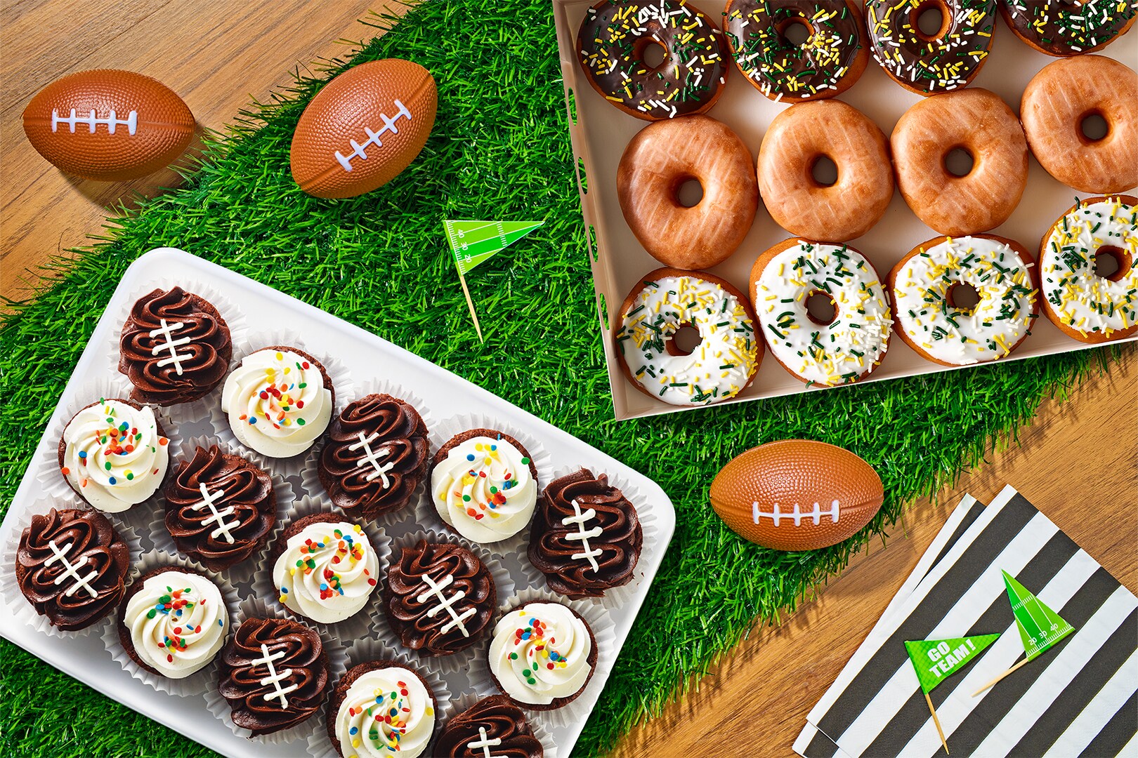 Football brownies and donuts on a faux grass table runner.