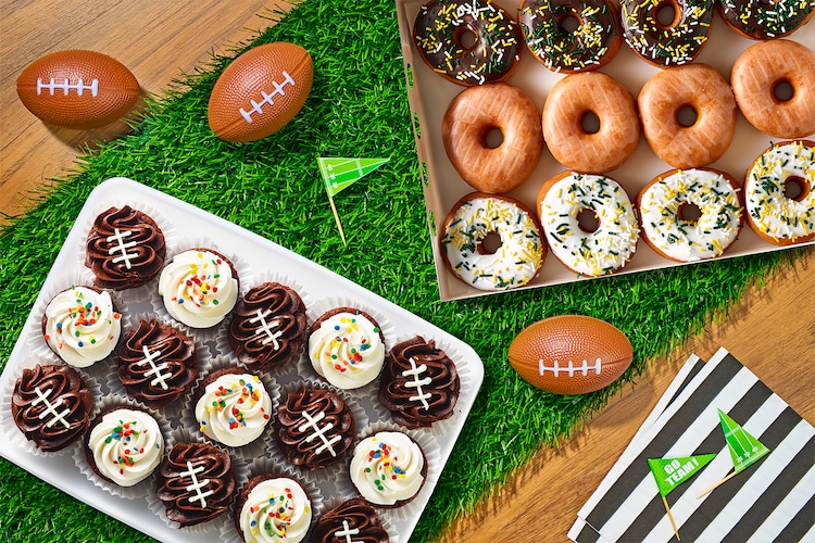 Football brownies and donuts on a faux grass table runner.
